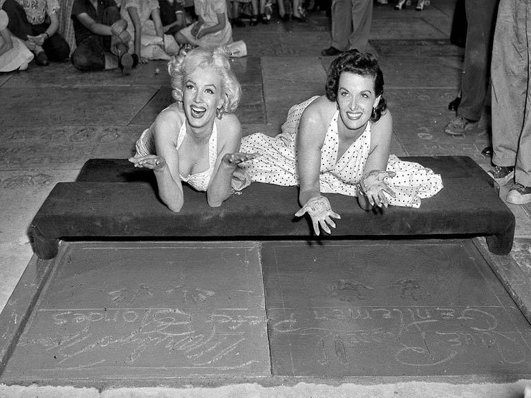 Marilyn Monroe and Jane Russell leave their handprints at Grauman's Chinese Theatre (1953)