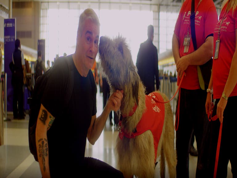 Henry Rollins gets a warm welcome from a PUP Program dog at LAX